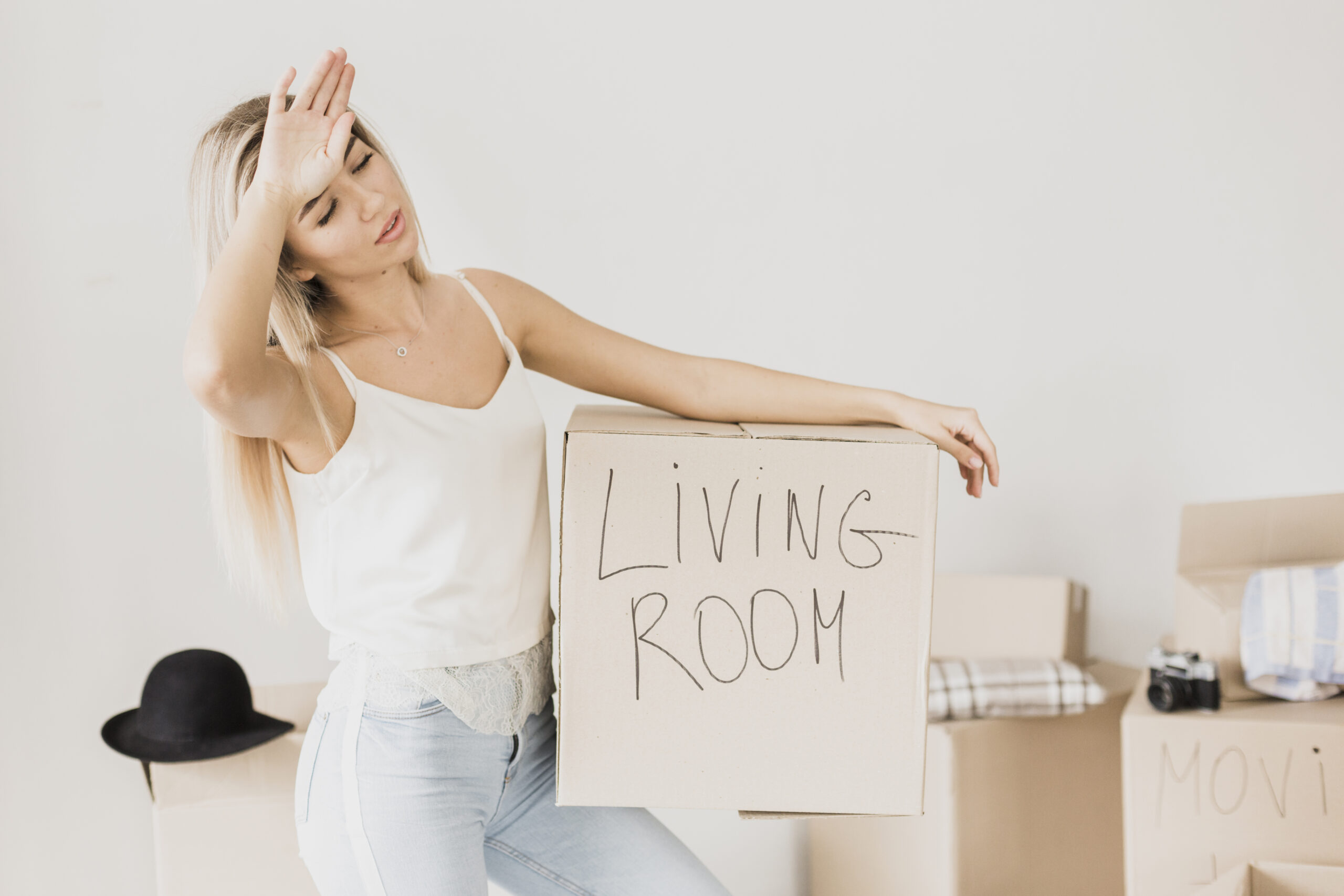 tired-young-man-holding-carton-box